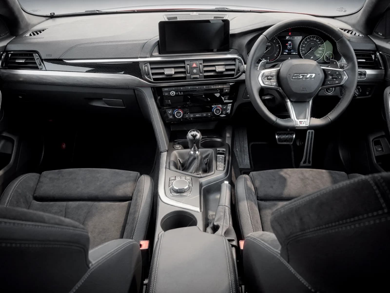 Sport sedan cockpit with a six-speed manual shifter, bolstered seats and a small-diameter steering wheel